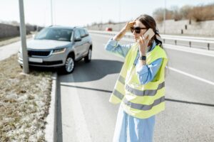 Woman calling during the road accident on the highway